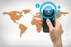 Composite image of hand holding smartphone with maps background
